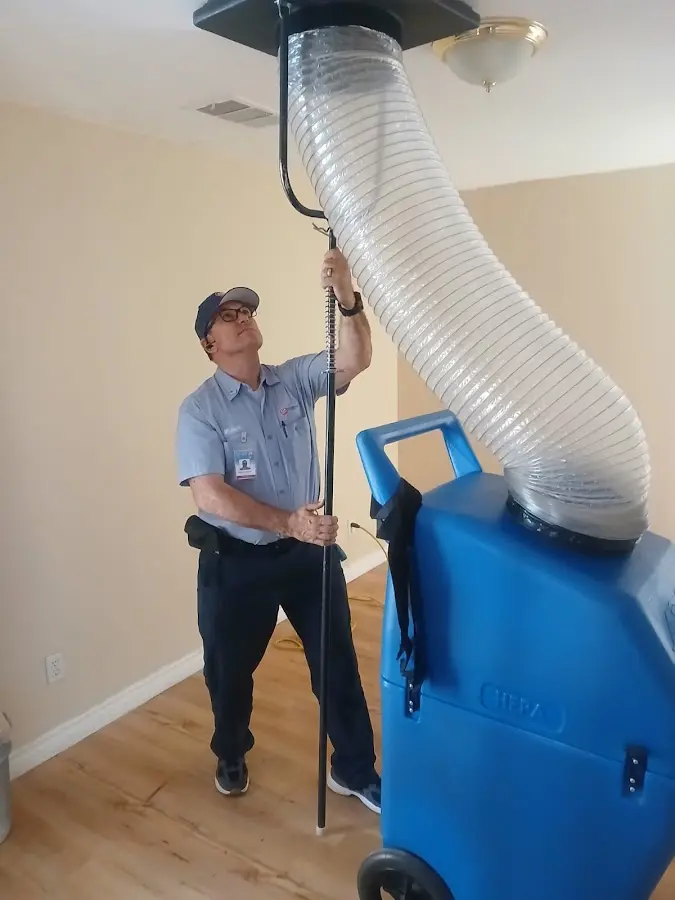 Furnace Tune-Up technician using HEPA equipment in Minneola